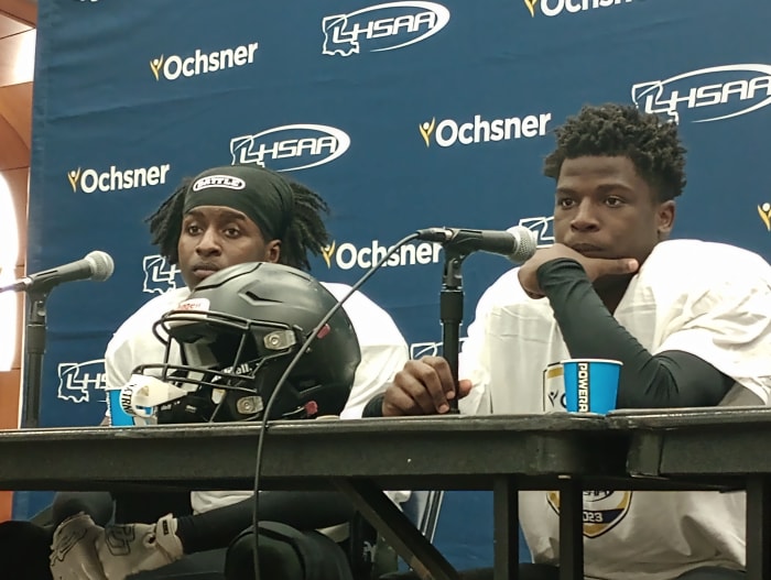 Oak Grove players TaMarques Prichard (left) and Jay Freeman listen to a question during a press conference following the Tigers' Division IV non-select championship win Dec. 7, 2023.